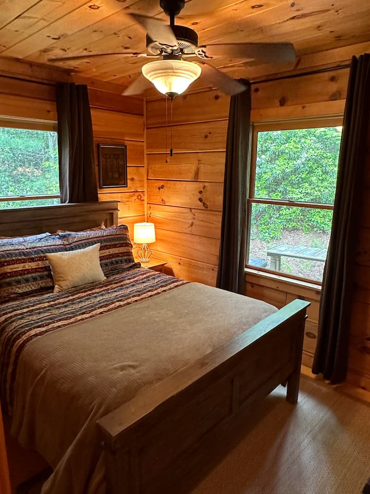 In bedroom two, you'll sleep soundly in the queen-size bed and wake to a beautiful wooded setting.