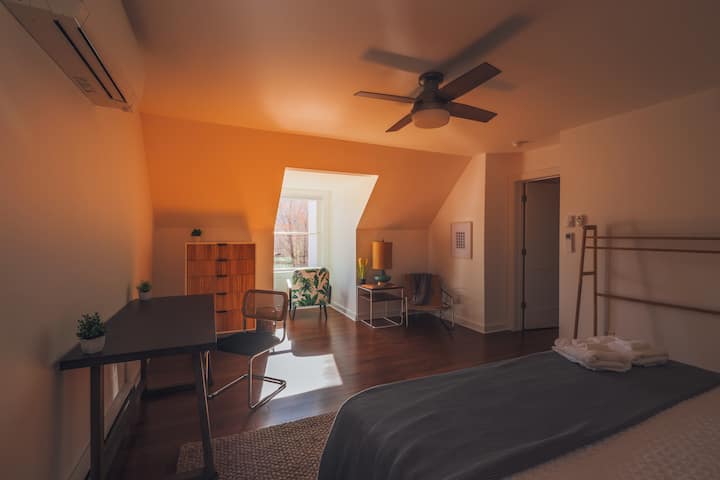 Our upstairs King room with a desk, reading nook, and mountain views. 

All bedrooms feature a Dohm white noise machine, ceiling fan and custom climate control. 