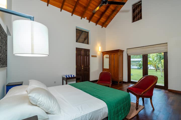 This is a medium bedroom (16ft x 14ft) and has an attached toilet with bath and shower. Has wooden parquet flooring and some antique wooden furniture like the cupboard & dressing table.Is air-conditioned and has a ceiling fan and smoke detector. 