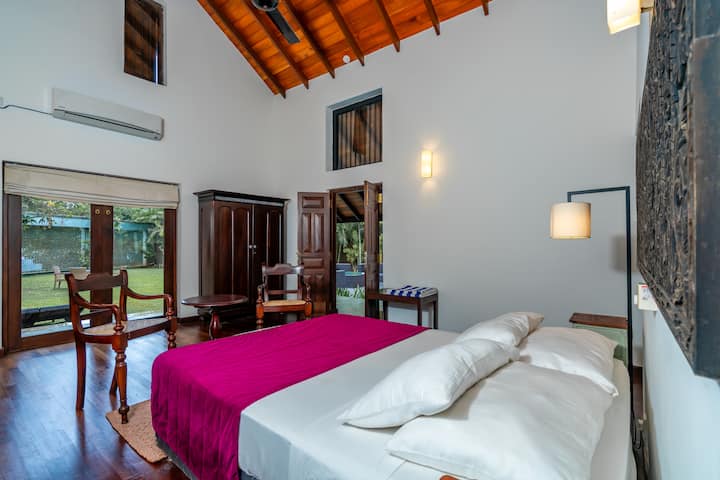 This is a medium bedroom (16ft x 14ft) and has an attached toilet with bath and shower. Has wooden parquet flooring and some antique wooden furniture like the cupboard & dressing table.Is air-conditioned and has a ceiling fan and smoke detector. 