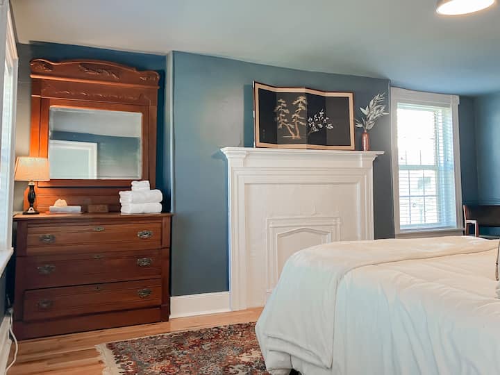 Cozy queen bed overlooking Main Street in the lovely Bedroom 1.