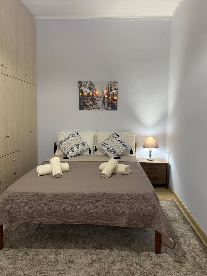 Second bedroom features a full-size bed, built in closet, and laminate flooring with a beautiful rug. 