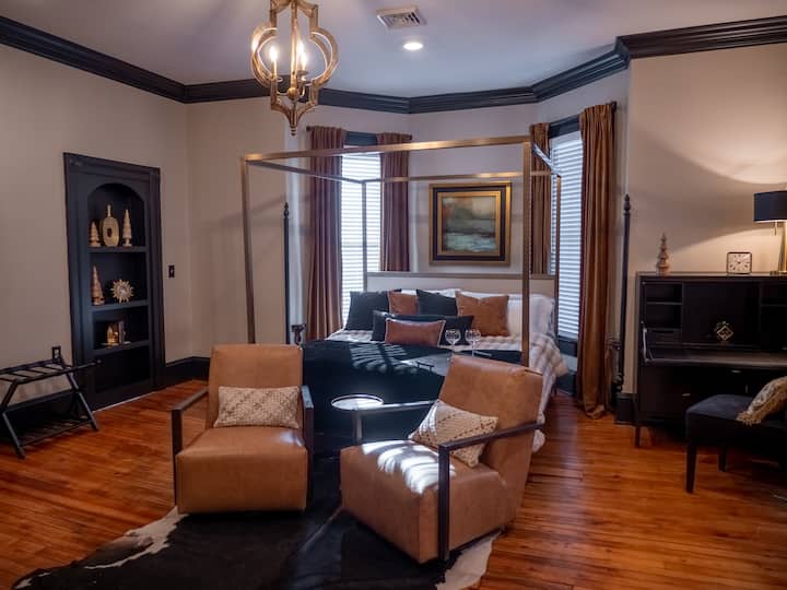 Our King Suite features an adjustable king size bed, dedicated workspace, two clothing dressers as well as a small hanging space.