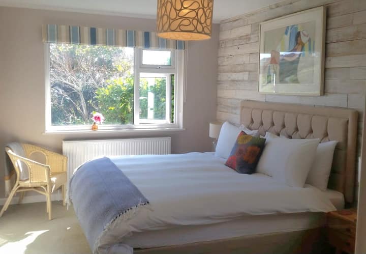 Super king size downstairs bedroom with view of the garden.