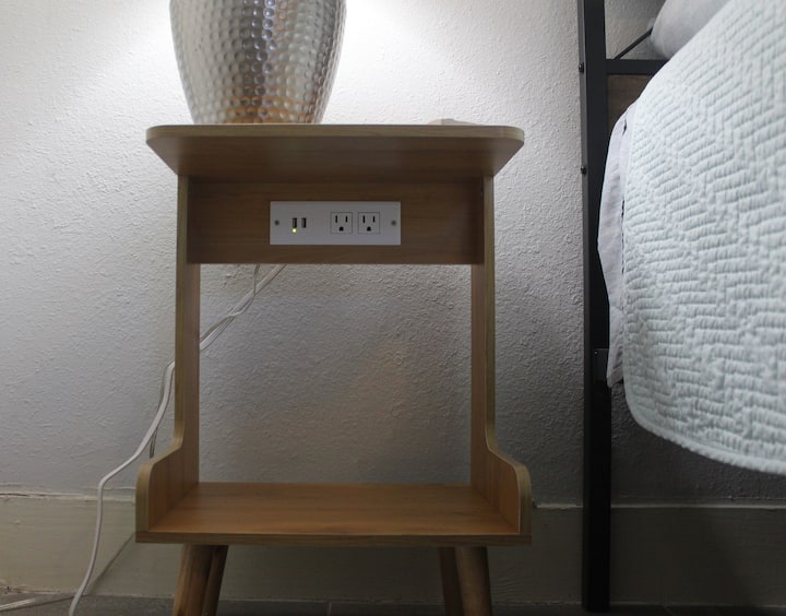 2 bedside tables in each bedroom room with 4 plugs for various devices. 