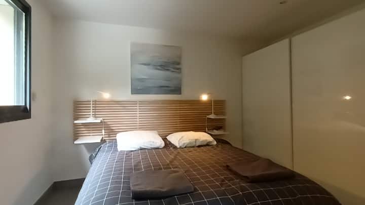 غرفة نوم رئيسية وسرير بحجم كوين وحمام، مع استوديو ومطبخ صغير يطل على حمام السباحة والجبل 