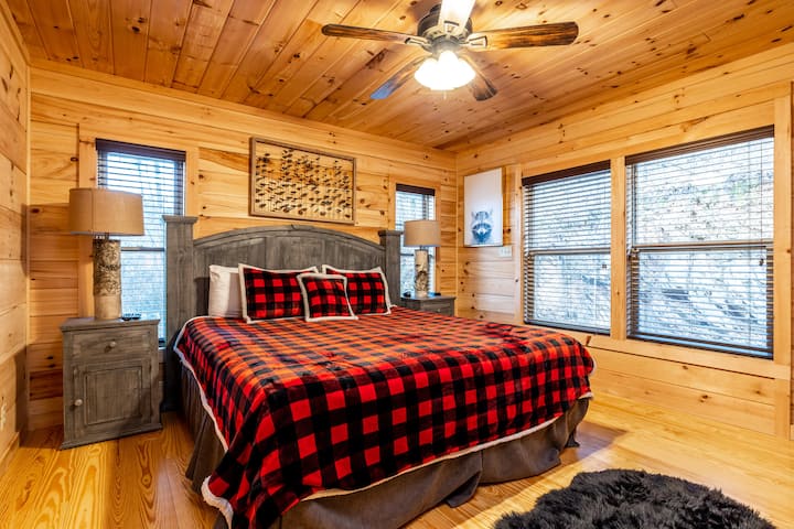 Bedroom 1: King bed, bright wooden accents and plush bedding create the perfect mountain escape!
