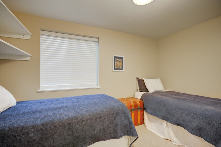 The lower level bedroom features two twin beds and an egress window for safety. 