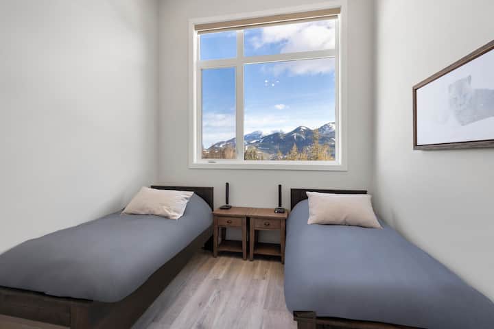 Enjoy Elk Valley views from the front bedroom featuring two comfy double beds, cozy décor, and a Smart HDTV with full cable—perfect for kids, friends, or extra guests to relax after a day in the mountains.
