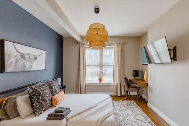 The main bedroom is upstairs and has a workspace and monitor. The bed is a queen size bed. TV is Roku with access to apps for streaming.