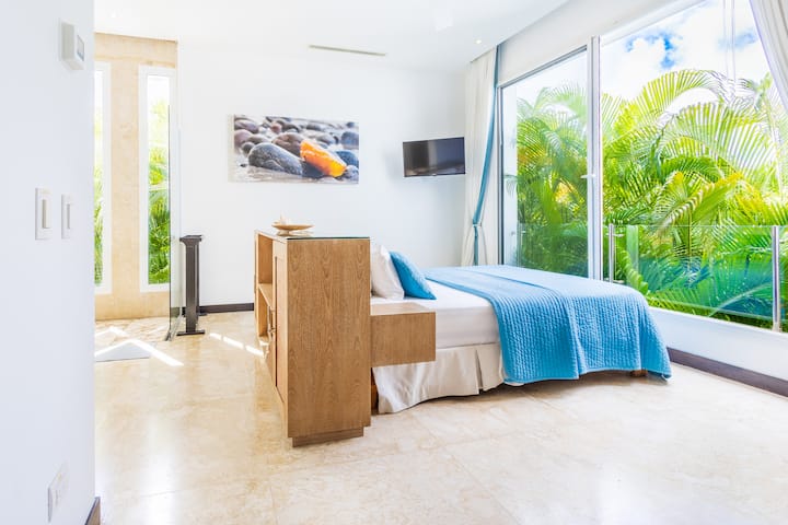 Comfortable and spacious bedroom with a queen bed and large windowns to the golf course! 