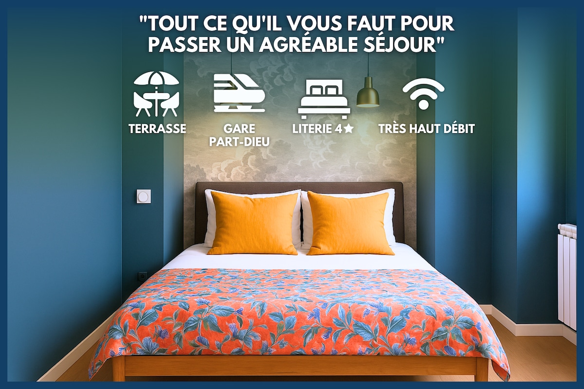A well-appointed sleeping area showcases a spacious bed with vibrant orange and blue accents. Decorative pillows enhance the inviting look. The wall is painted in a calming green, while a colorful floral bedspread adds a touch of warmth to the room.