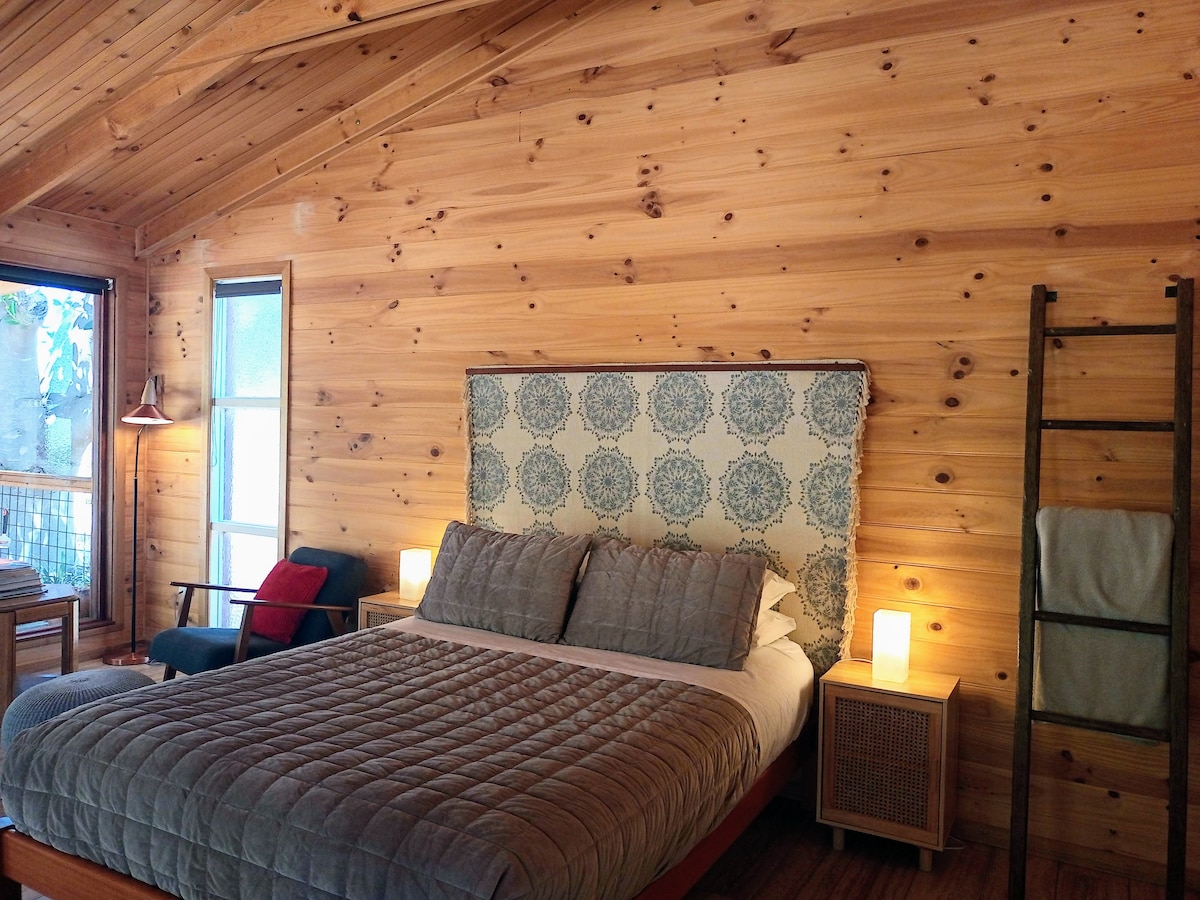 Comfortable queen-size bed, near a cosy reading corner. Enjoy the generous open-space studio in Southern Barossa Valley.