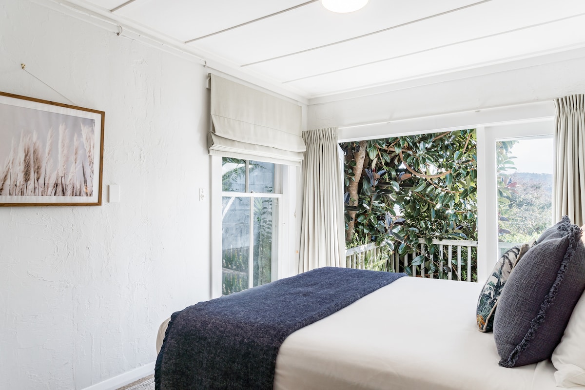 ห้องนอนเปิดออกสู่ดาดฟ้าต้นไม้เขียวขจีและวิวน้ำที่สวยงาม 