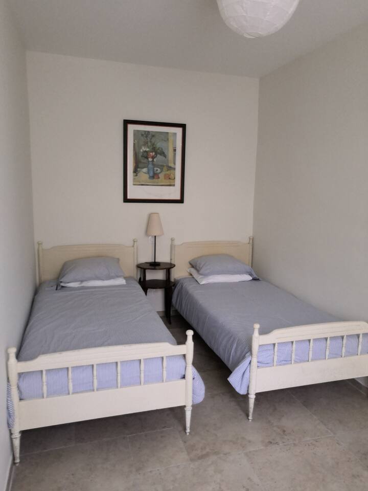 The second bedroom has two single beds complete with bedding suitable for the different seasons.
More pillows or blankets are available if required. 
All bedding is non-allergic (i.e. no feathers or wool).
Two sockets are between the beds for phones.