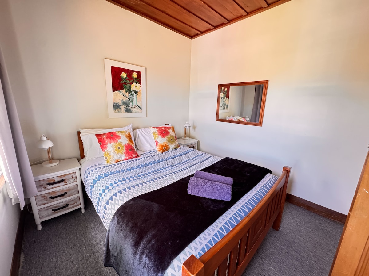 Smaller room of the two and located at the front of the house with a queen bed