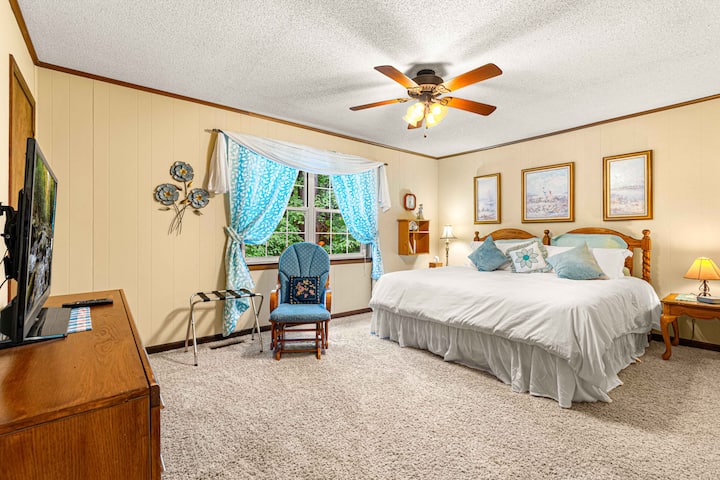 Master bedroom with king-sized comfortable bed. Window overlooks the back yard.