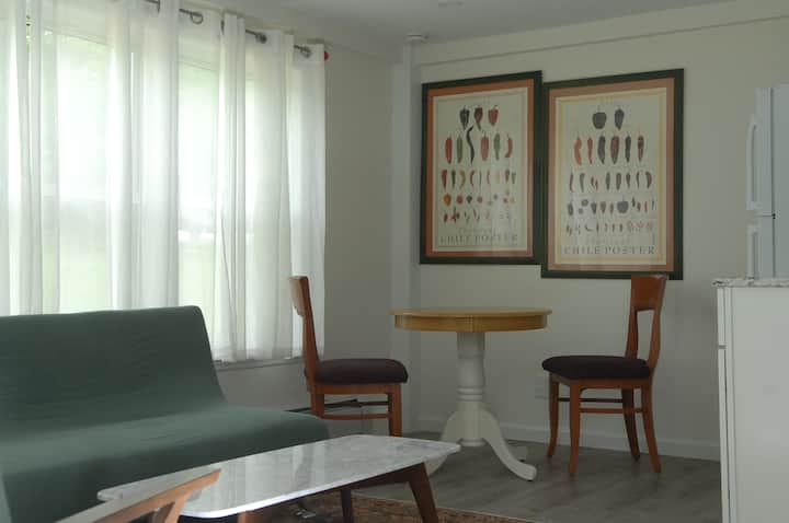 Unit 4 - living room/kitchen with double sized sofa bed and dining area.