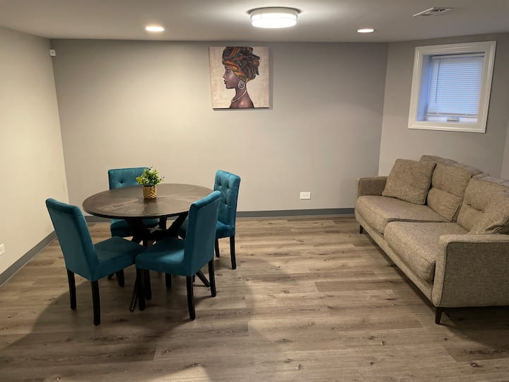 Lower level living room includes couch, table and 40 inch tv