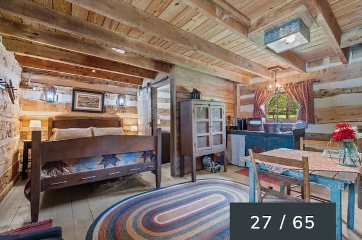 Picture showing downstairs Queen bed view from the living area into the kitchenette.  Bathroom is located in the room next to the queen bed.