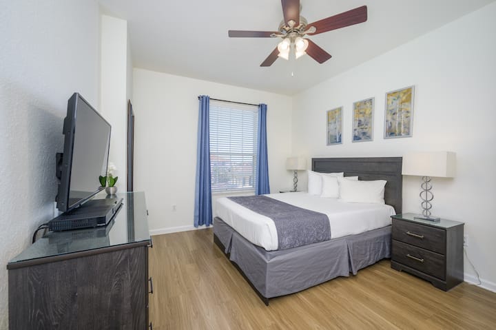 2nd bedroom with queen size bed, closet, drawers, and 43" Smart TV