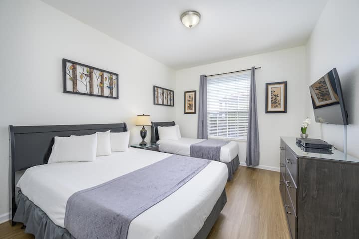 2nd bedroom with queen size AND twin bed, closet, drawers, and 43" Smart TV