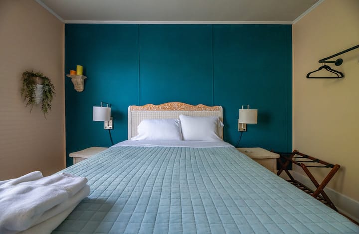 A queen bed is featured in second bedroom. 