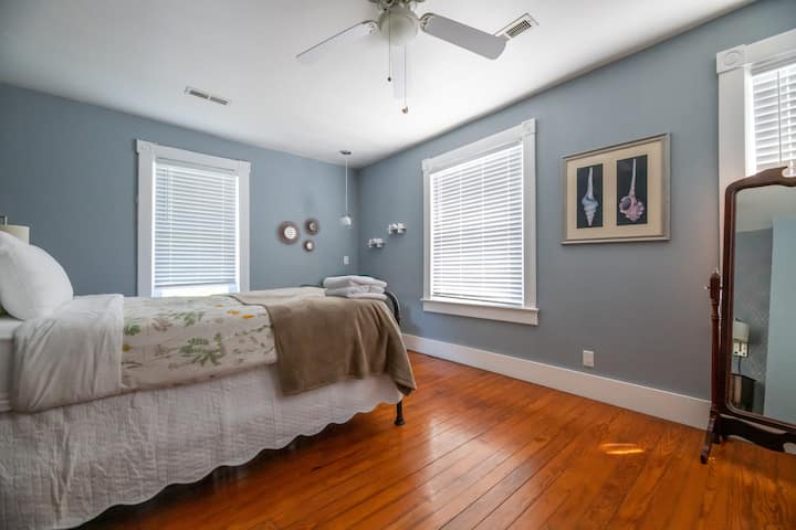 The main bedroom features a queen size bed, comfortable chair and ample storage for guests items. 