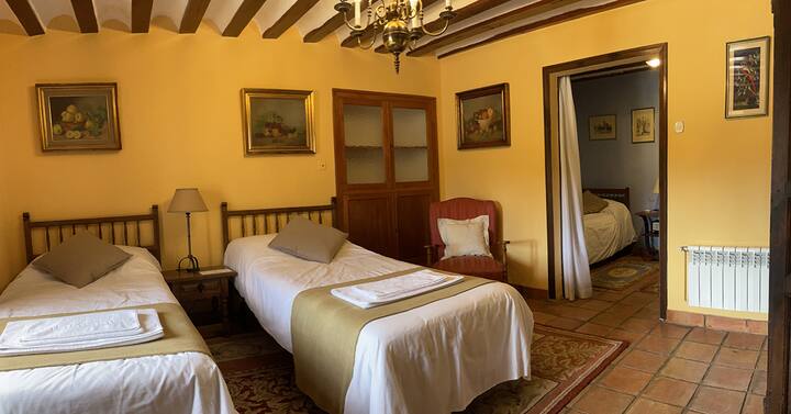 Bedroom "La Parra":
Located on the ground floor, it has two twin beds and an extra bed in a separate room.