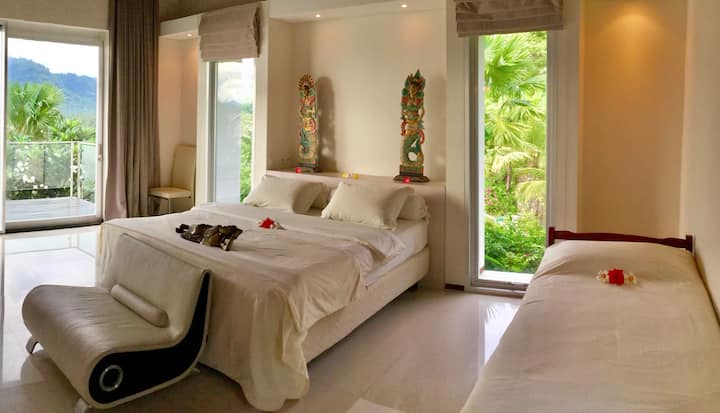 The first bedroom, with a king sized bed and two single beds.