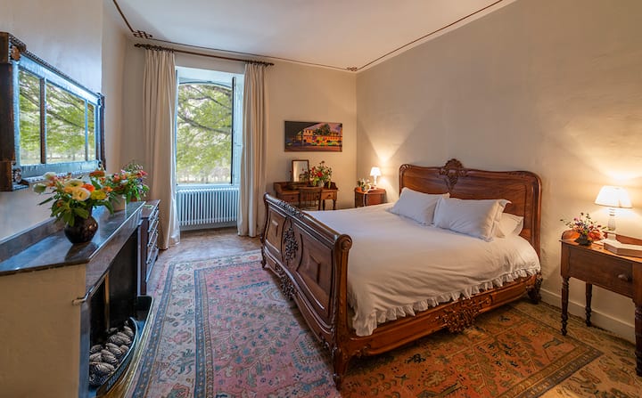 Bedroom #4, with a double bed, offers a traditional respite, adorned with an antique bed and harmonious décor, promising guests a restful retreat from the world.