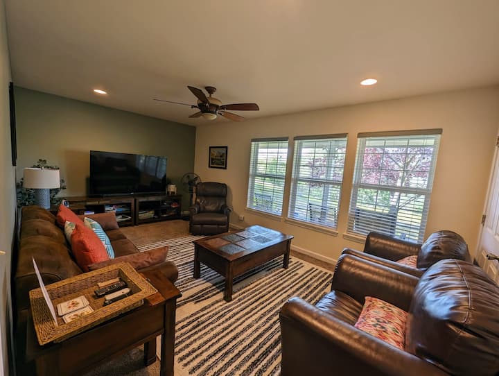 Blending warm leather furnishings, natural light, and refined decor, this living area offers understated luxury, providing a serene and spacious setting for restful moments after local adventures.
