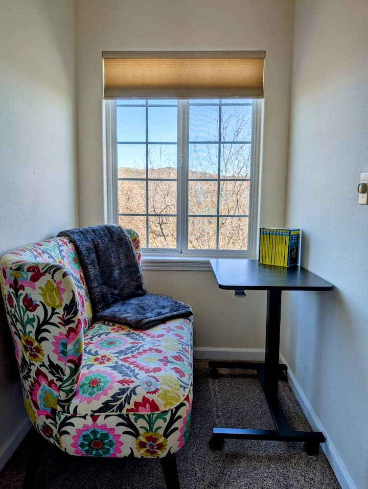 A stylish, upholstered seat paired with serene window views creates a softly luxurious space ideal for unwinding, reading, or settling into calm reflection during your stay.
