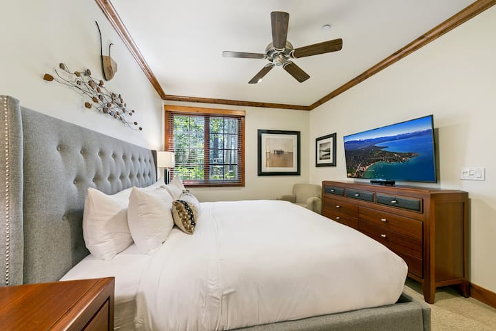 Retreat to the primary suite with a plush king bed, 40” HDTV, and a spa-inspired ensuite featuring a jetted tub, steam shower, and dual sinks.
