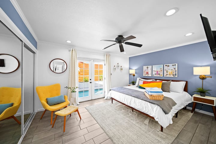 Primary bedroom with king bed and memory foam topper, closet, smart TV, and direct access to the backyard pool and spa. 