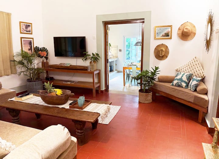 As you lounge on the comfy couch, enjoy the view through the open doorway of the indoor-outdoor kitchen that leads straight to your pool and cabana space. An open invitation to slow down and immerse yourself in the easy rhythm of tropical living.