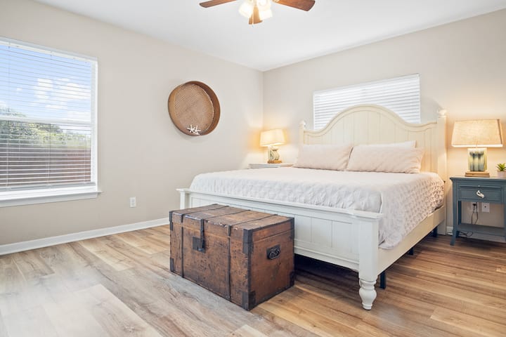 Spacious master suite featuring a plush king bed that guests consistently rave about for its comfort. A peaceful retreat to unwind after a beach day, offering hotel-level relaxation with all the comforts of home.