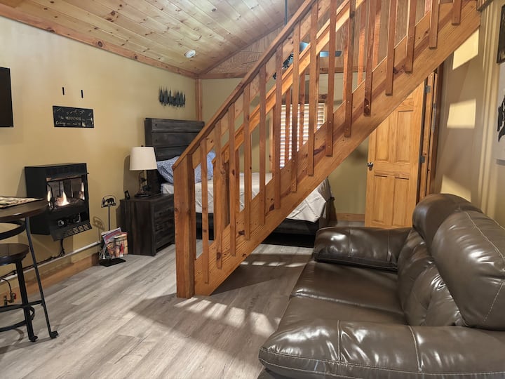 Queen bed located in the common area of cabin