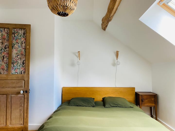 The upstairs bedroom with a queen size bed and a single bed