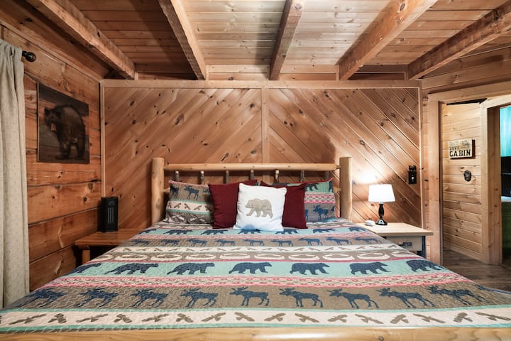 Snuggle up in this comfy bed with soft bedding and plenty of pillows.