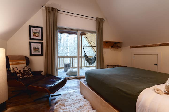 Call dibs on this loft primary suite with a queen bed, Eames chair, full bath, coffee/mini fridge/microwave, and the ultimate retreat - private access to the third-story screened deck with hammock chairs. True, open loft access.