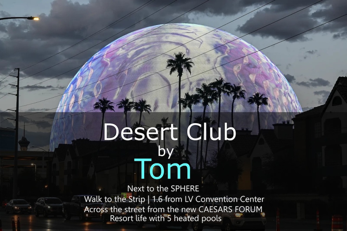 The image captures a striking view of the Sphere, with vibrant colors illuminating the structure against a dusky sky. Silhouetted palm trees frame the scene, adding a natural touch to the urban landscape, while nearby buildings are softly lit, hinting at the lively atmosphere of the area.