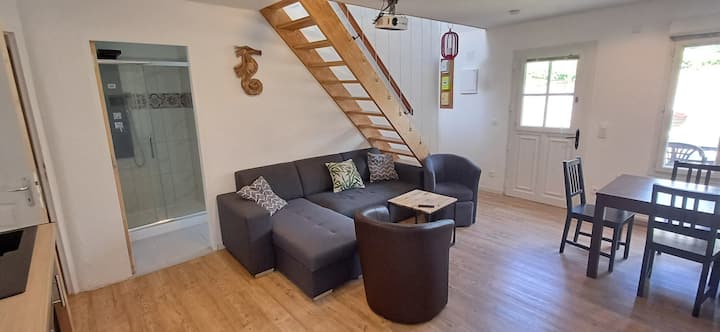 sofa bed of the cottage la paillote the third lodge of the chatô living room with a video projector