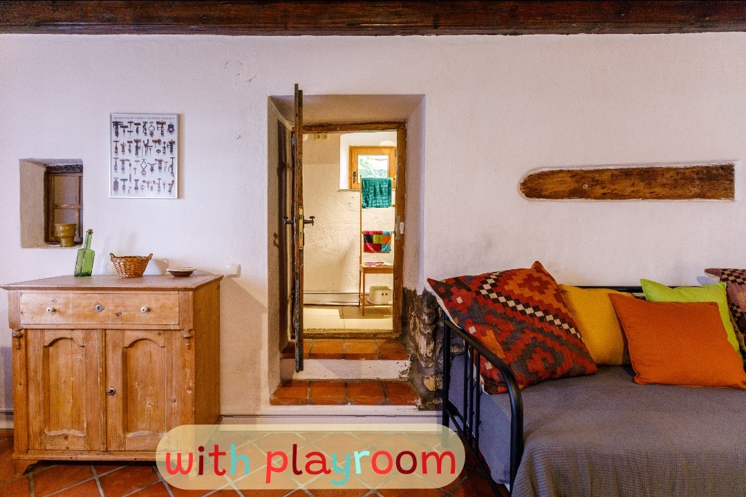 In the fall of 2023, we set up an indoor playroom in the attic for ovis and schoolies. Folk and breed toys, a corn blanket, and a set of wood trains help the kids book it-so parents have time to relax here, too.