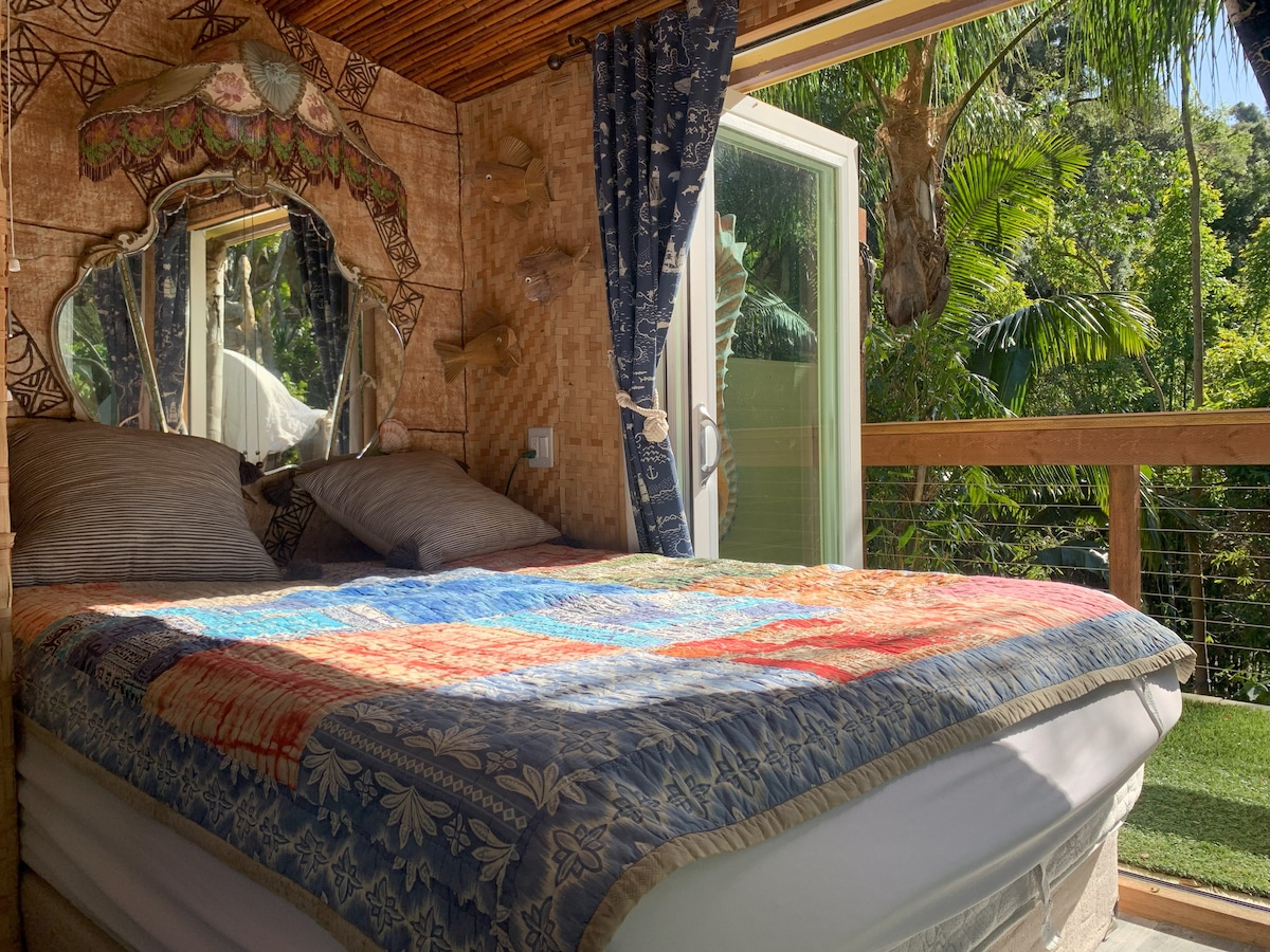 Bedroom with vintage decor and double porch doors that open fully for a splendid view.
