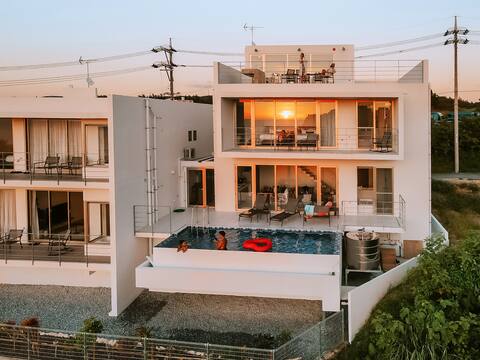 Blue Rela Luxe Resort Okinawa, a villa with a pool surrounded by nature