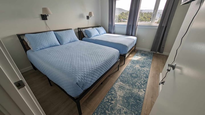 Second bedroom. Two double beds with high end memory foam. This room has it's own TV and access to a bathroom as well.