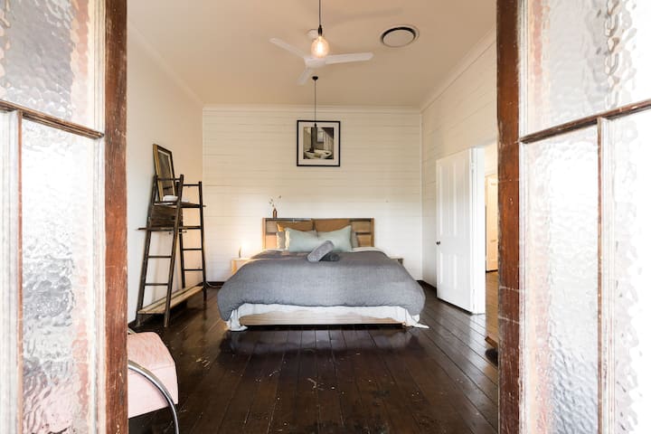 The Aubrey room. Storage and hanging space. King bed with Hale Mercantile linen. South-facing.