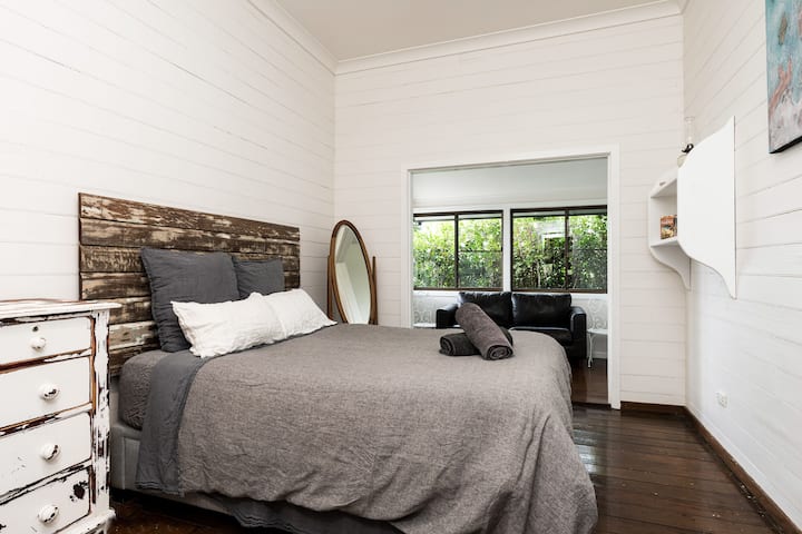 The Bella Room. Queen bed with Hale Mercantile linen and separate lounge space.