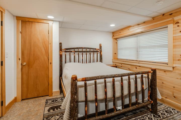 חדר שינה במרתף עם מיטת קווין סייז ומזרן נוח.